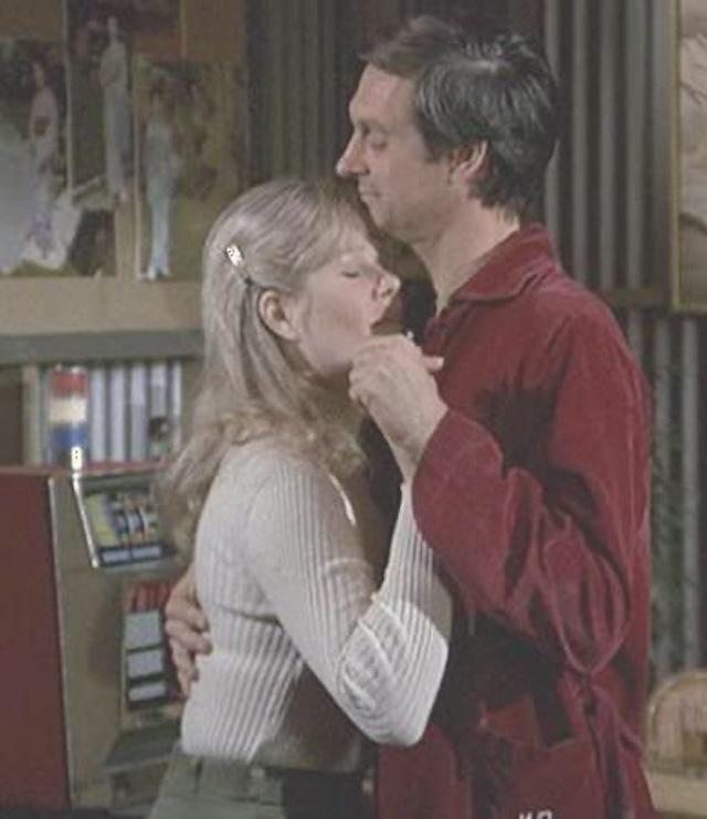 Loretta Swit as Margaret "Hot Lips" Houlihan dances with Alan Alda as Hawkeye Pierce in a tender moment on M*A*S*H, highlighting the evolving dynamic between the two characters.